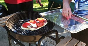 Adding toppings to grilled pizza